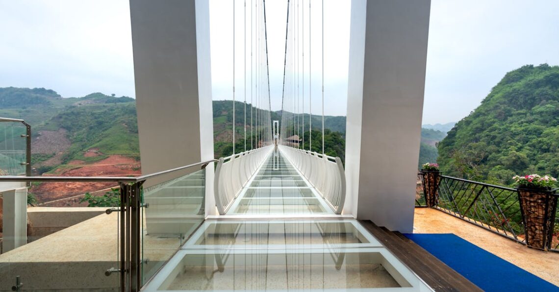 Stunning glass bridge with panoramic mountain views, perfect for adventurous tourists.