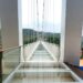 Stunning glass bridge with panoramic mountain views, perfect for adventurous tourists.