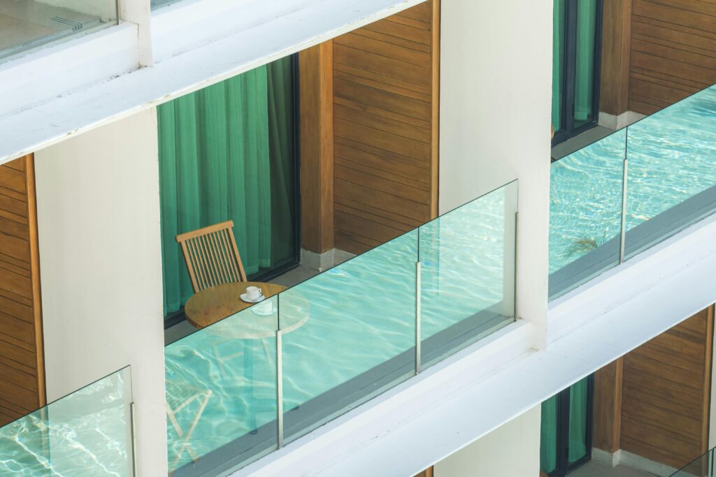 Stylish balcony in Tagaytay with glass railing, wooden elements, and seating.